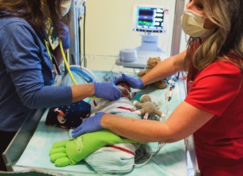 doctors with small baby
