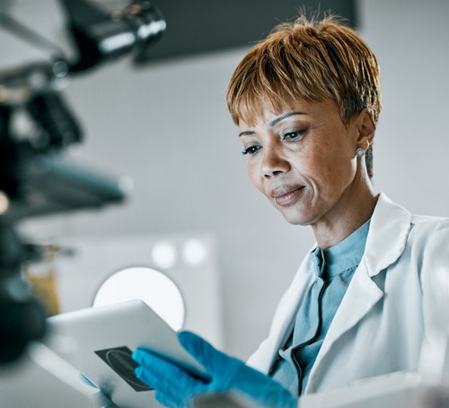 researcher reviewing research on a tablet - Pillar 1
