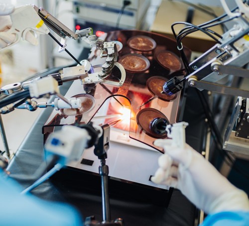 researchers with robotics surgery